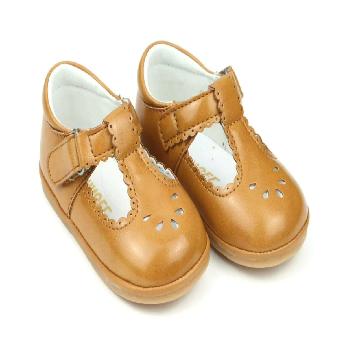 A pair of mustard Dottie Scalloped T-Strap Mary Jane shoes for baby girls with a hook and loop velcro strap and scalloped trim detailing.