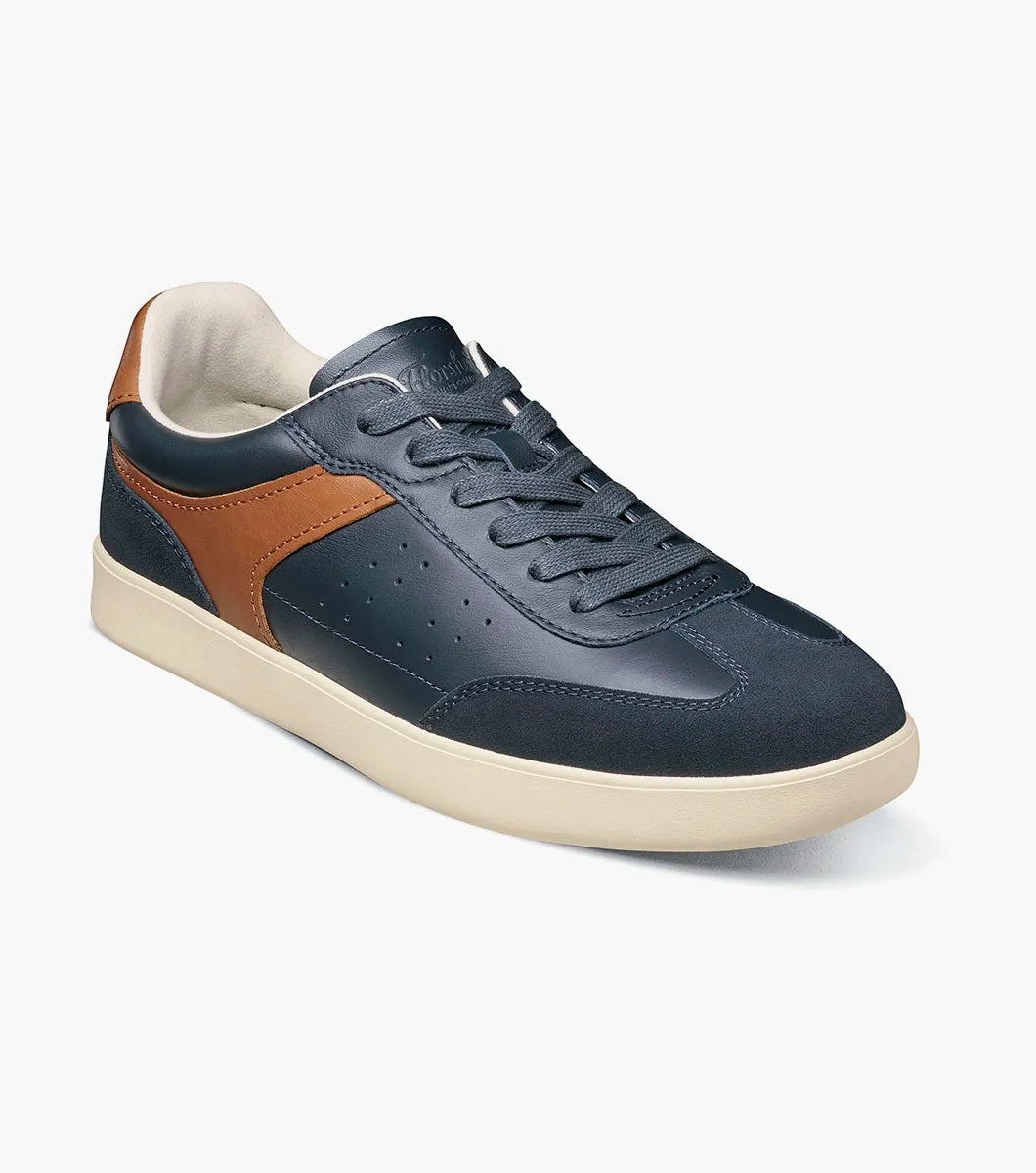 Navy sneaker with brown accents on a white background